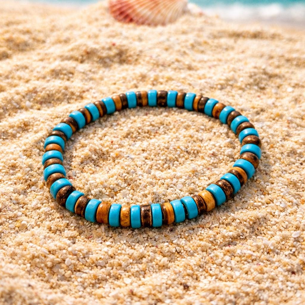 Turquoise stone and coconut shell bracelet on sand background