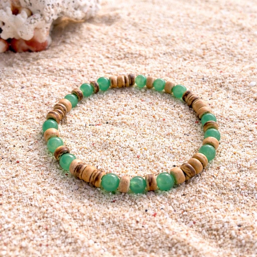 Green aventurine bracelet with natural shell beads on sand