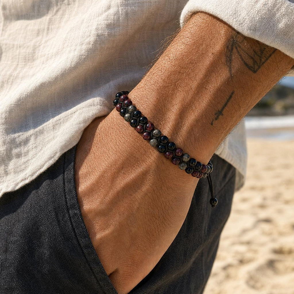 May include: A double-strand beaded bracelet featuring alternating dark red and black spherical beads. The bracelet is constructed with a black cord and includes an adjustable sliding knot closure with two small dangling beads at the end of the strings.